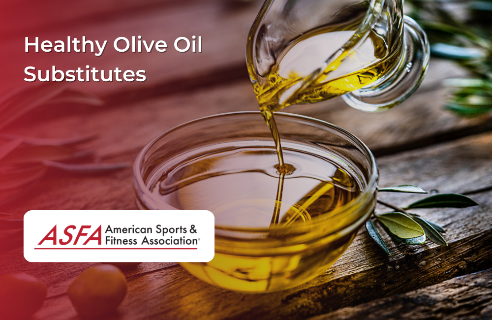 A small glass bowl of olive oil with oil being poured from a glass container.