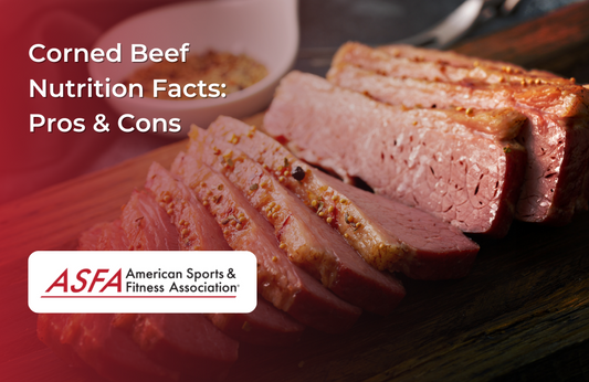 Sliced corned beef with mustard seeds on a wooden cutting board.