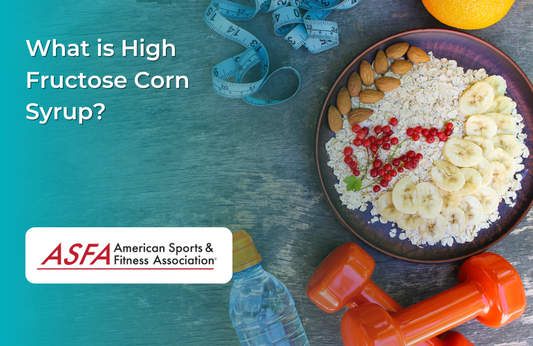 Bowl of oatmeal with bananas and nuts with orange dumbbells, a measuring tape, and a bottle of water around it. .