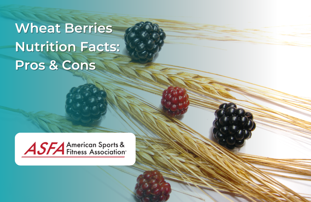 Wheat stalks and blackberries on a wooden surface.