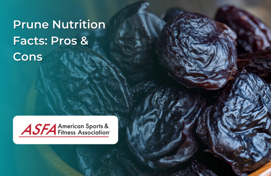 A close-up of dark, wrinkled prunes piled together in a wooden bowl.