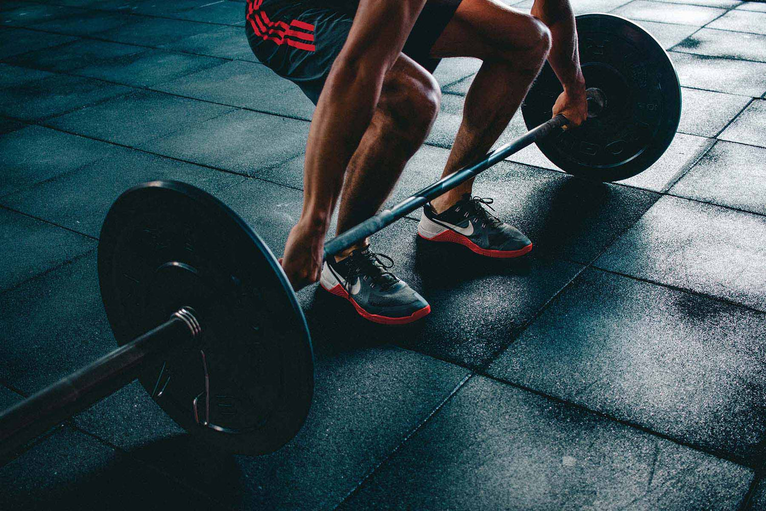 Man weight training in starting position for clean and jerk exercise