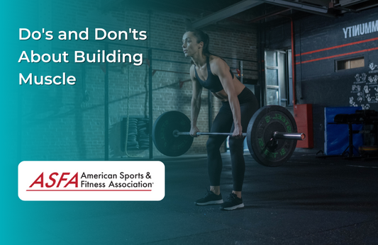 A fit woman performing a deadlift with a barbell in a dimly lit gym.