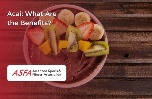 A vibrant acai bowl topped with sliced kiwi, bananas, strawberries, and mango.