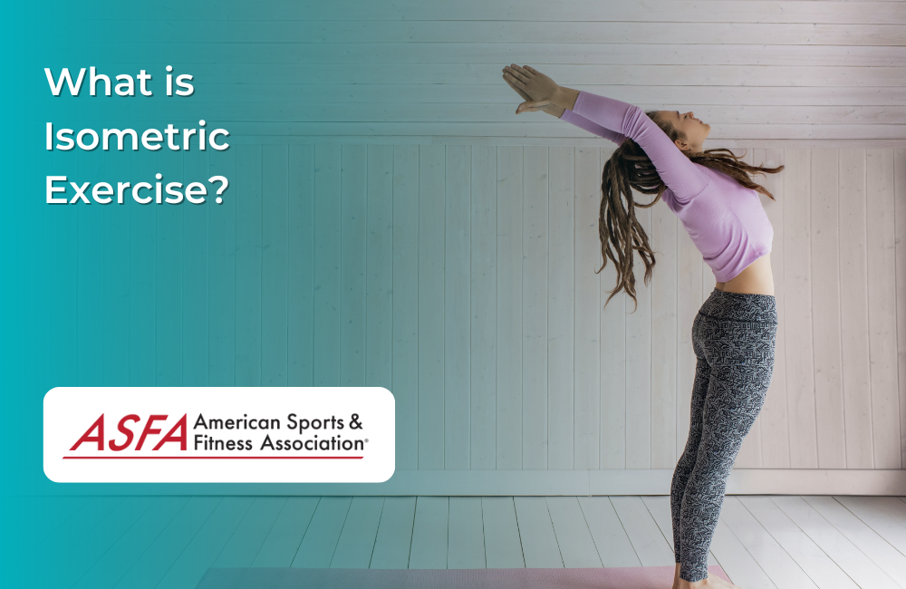 Lady in purple shirt doing yoga inside a light colored room.