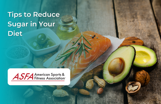 A wooden table with salmon, avocado, olives, nuts, and other healthy fats.