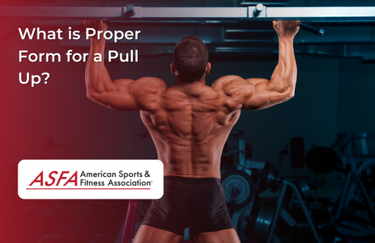 A muscular man performs a pull-up in a gym, displaying a strong back and arms.