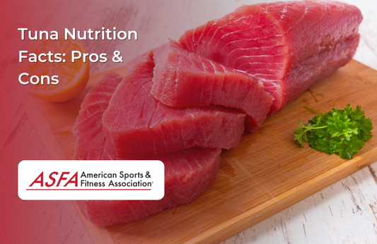 Fresh tuna fillets on a wooden cutting board with a garnish of parsley and lemon.