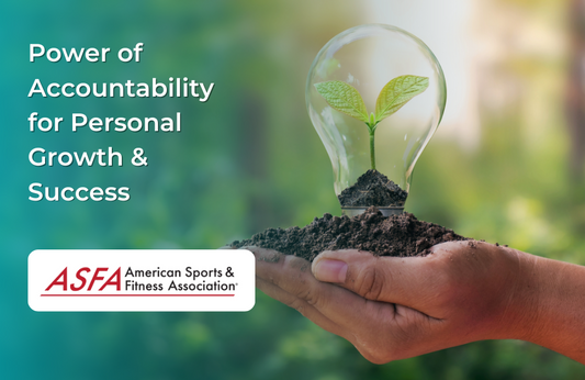 A pair of hands holds soil with a sprouting plant inside a lightbulb against a blurred green background.
