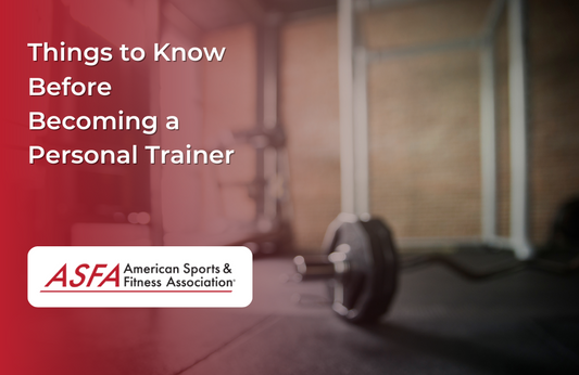 A barbell resting on the floor in a dimly lit gym.