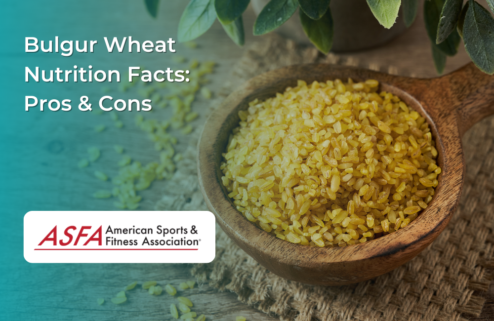 A wooden bowl filled with golden bulgur wheat grains with a wooden spoon resting on top.