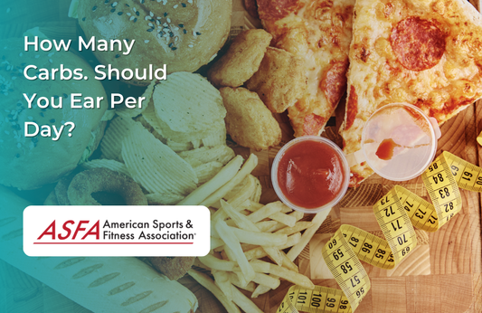 A spread of carb-heavy foods like pizza, fries, burgers, and chips, with a measuring tape on a wooden surface.