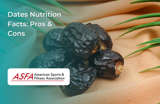 A few glossy black dates on a textured beige cloth with green leaves in the background.