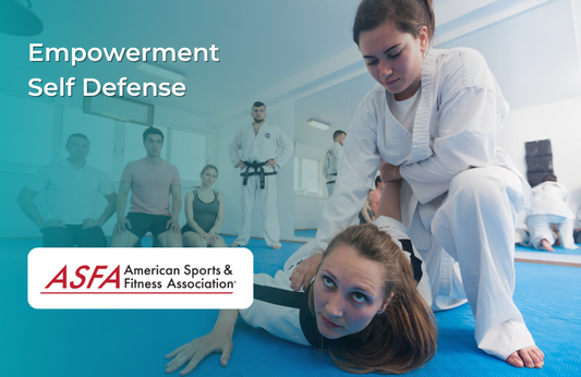 A martial arts class with a female student performing a controlled takedown on another woman in a white gi, while other participants observe in a training room.