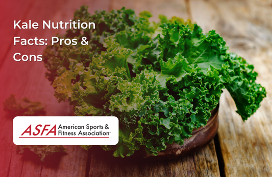 A bowl of fresh, curly green kale on a rustic wooden table.