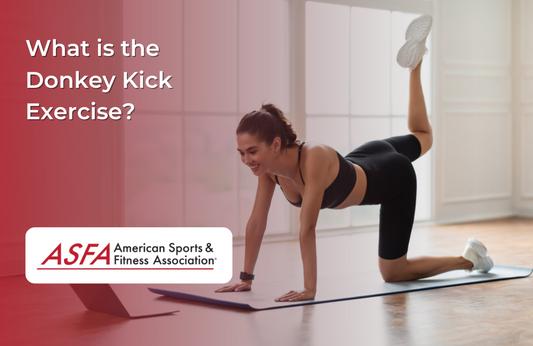  A woman performing a donkey kick exercise on a yoga mat indoors, looking at a laptop screen.