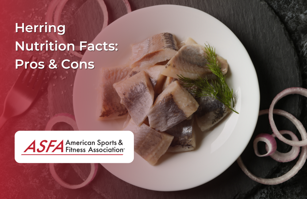 A plate of pickled herring garnished with dill and red onion slices on a dark slate surface.