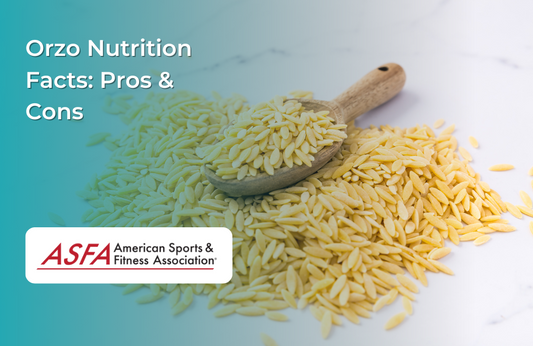 A pile of orzo pasta on a white surface with a wooden spoon.