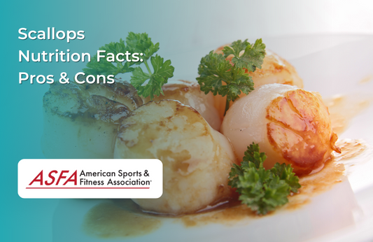 Seared scallops garnished with parsley, presented on a white plate with sauce.