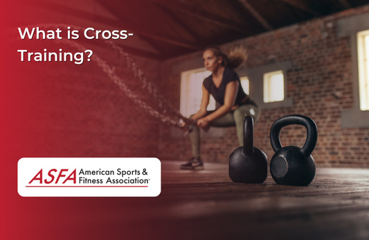 Lady doing functional fitness exercise in the background and two black kettlebells in the foreground..