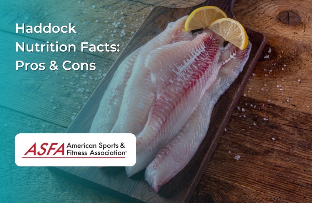 Fresh haddock fillets on a wooden board, garnished with lemon slices and sea salt.