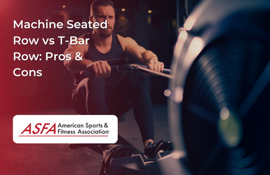 A man in black in a dark gym doing rowing exercises.