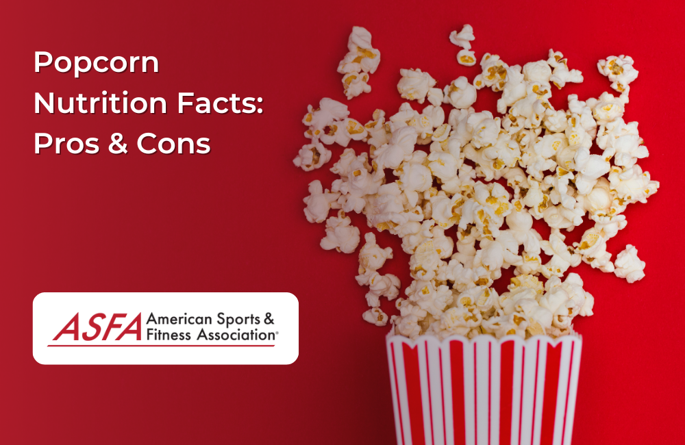 A classic red-and-white striped popcorn container overflowing with fluffy popcorn against a bold red background.