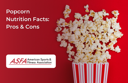 A classic red-and-white striped popcorn container overflowing with fluffy popcorn against a bold red background.
