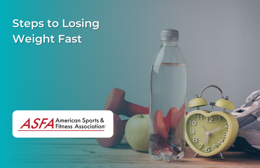  A bottle of water, an apple, an alarm clock, and a dumbbell on a table.