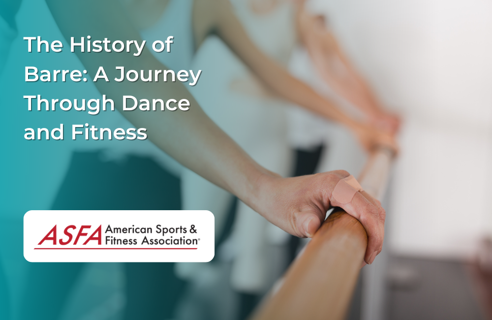 Hands gripping a wooden barre in a fitness studio with people in the background.