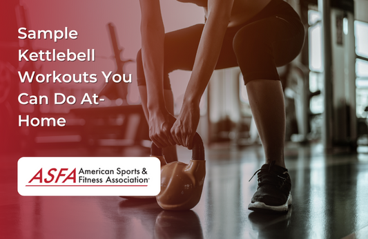 A person in workout clothes, preparing to lift a kettlebell in a gym environment.