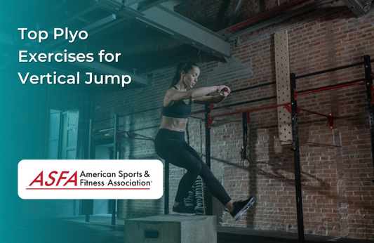 A woman in a black outfit performing a box jump in an industrial-style gym.