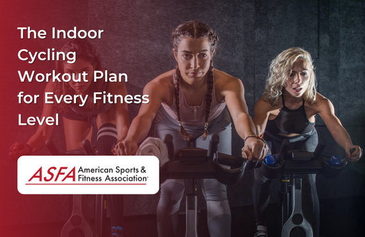 Three women intensely cycling on stationary bikes in a dark fitness studio.