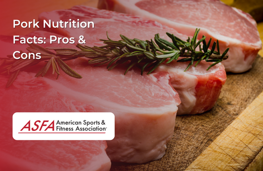 A wooden cutting board with raw pork chops garnished with fresh rosemary.