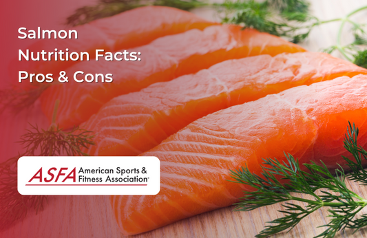 Fresh salmon fillets arranged on a wooden surface with sprigs of dill.