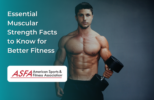 A shirtless man standing confidently and holding a dumbbell in one hand, highlighting muscular definition in a fitness studio.