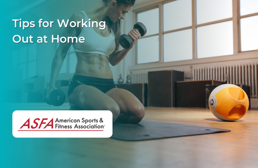 A woman kneeling on a yoga mat lifting dumbbells in a bright home gym.