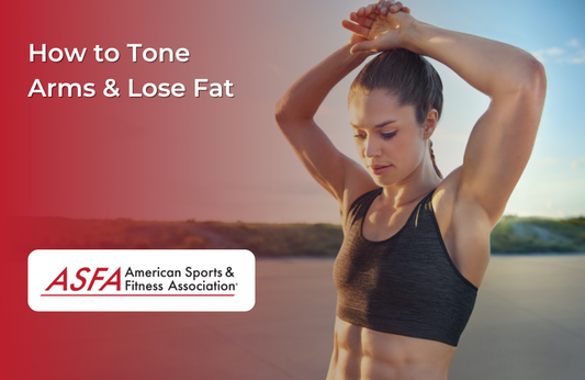 Lady in black sports bra with arms over her head, standing by a body of water outside..