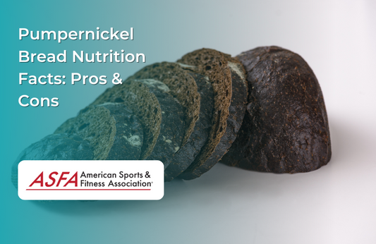A sliced loaf of dark pumpernickel bread on a light background.