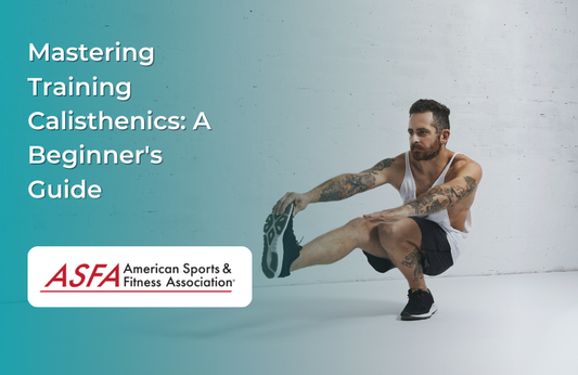 A man with tattoos performs a pistol squat against a plain wall.