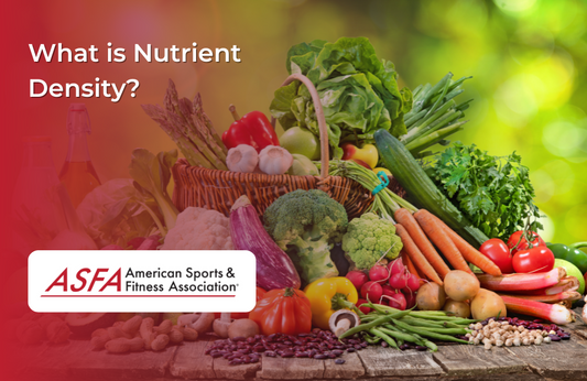 Basket with vegetables in and around it like carrots, broccoli, peppers, tomatoes, garlic bulbs, egg plant, asparagus, and lettuce on a wooden surface outside. 