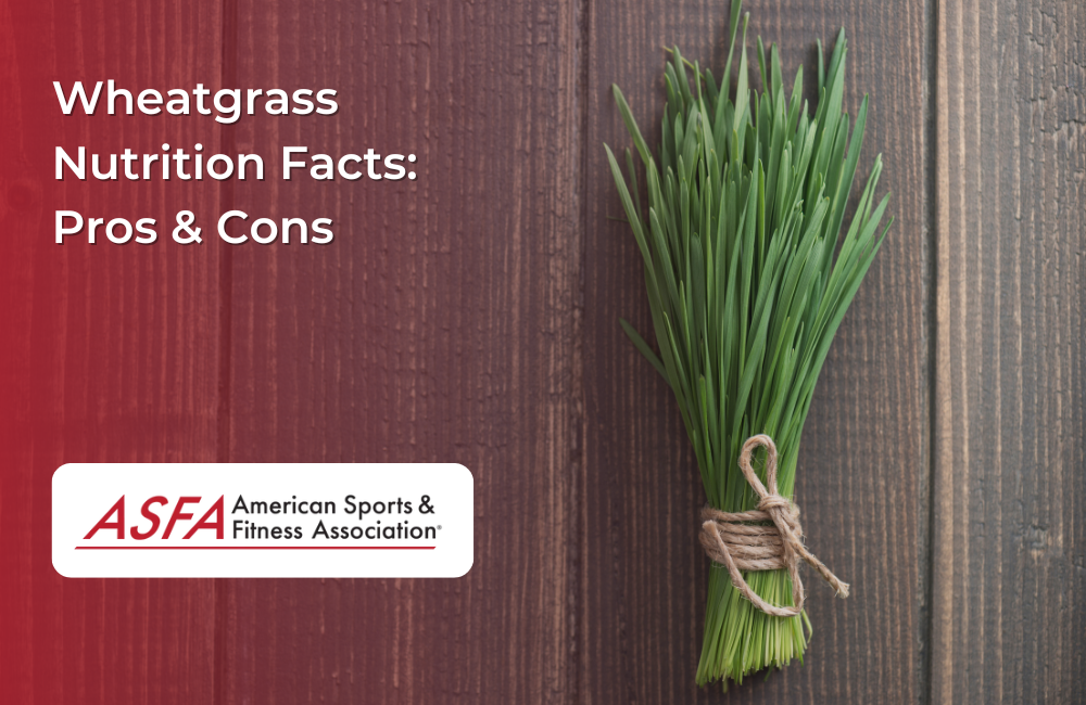 A tied bundle of fresh wheatgrass stalks on a rustic wooden background.
