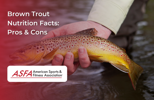 A person holding a brown trout over a river or stream.