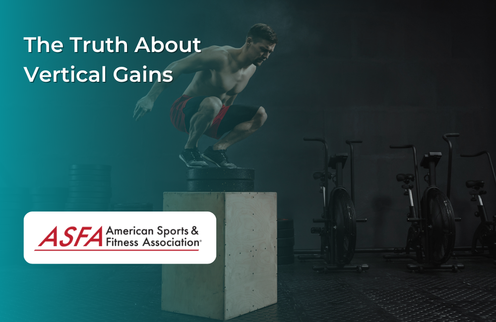 A man in red shorts performing a box jump in a dimly lit gym.