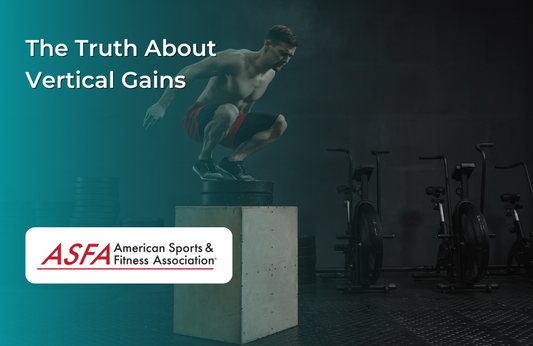 A man in red shorts performing a box jump in a dimly lit gym.