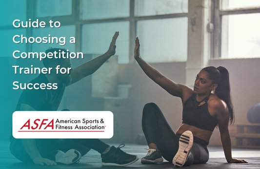 A man and woman in workout clothes give each other a high five while sitting on a gym floor mid-exercise.
