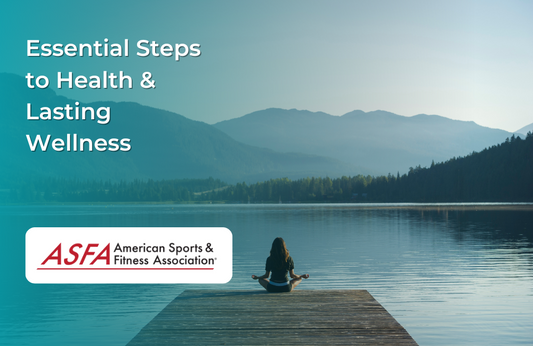 A person sitting in a meditation pose at the edge of a dock overlooking a calm lake and surrounding mountains.