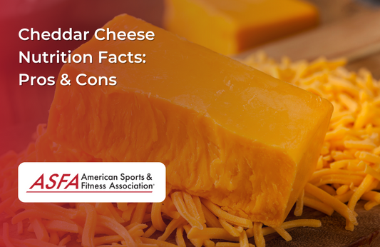 A block of cheddar cheese with shredded cheese scattered around it.