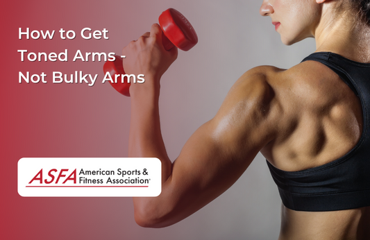 A fit woman lifts a red dumbbell, showcasing her toned arm muscles.