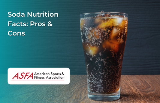 A tall glass of soda with ice cubes, showing bubbles rising against a dark wooden background.